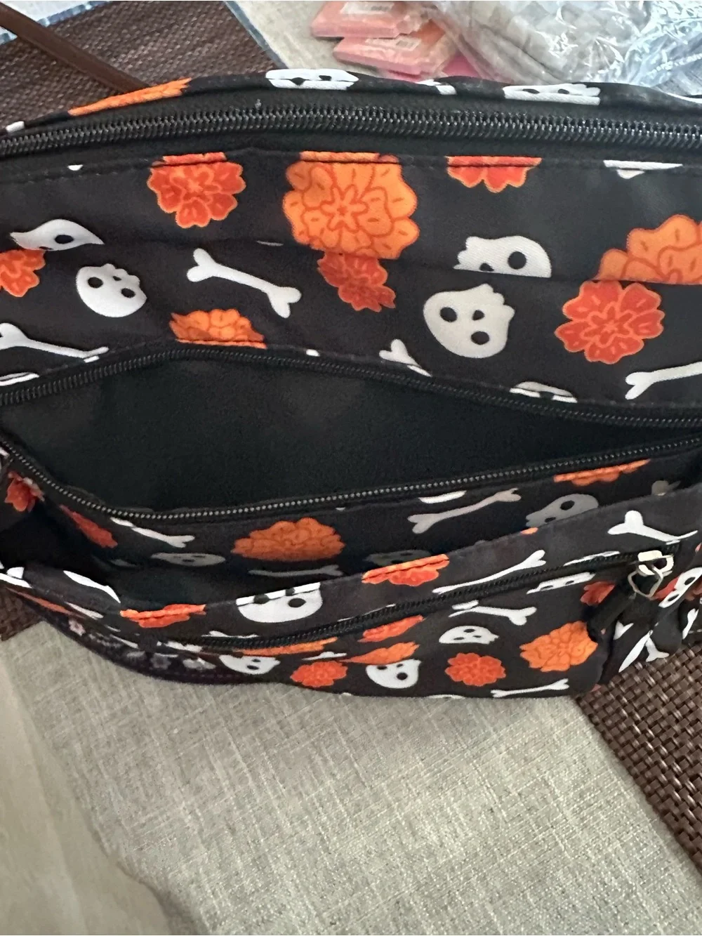 Halloween-themed crossbody bag featuring a skull and marigold print